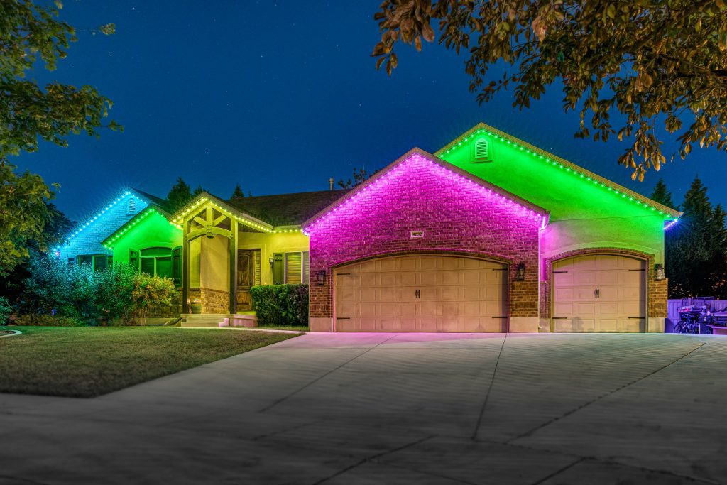 Bright pink, green, blue and yellow lights on front of house